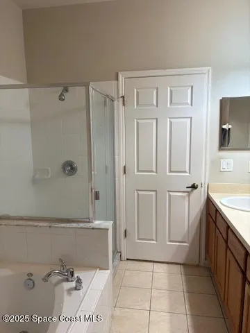 a bathroom with a tub sink and mirror