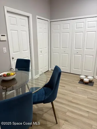 a view of a room with furniture and wooden floor
