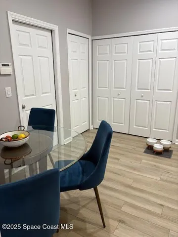 a view of a room with furniture and wooden floor