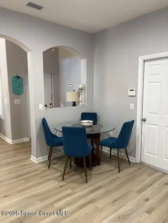 a view of a dining room with furniture and wooden floor