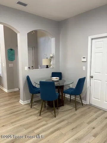 a view of a dining room with furniture and wooden floor