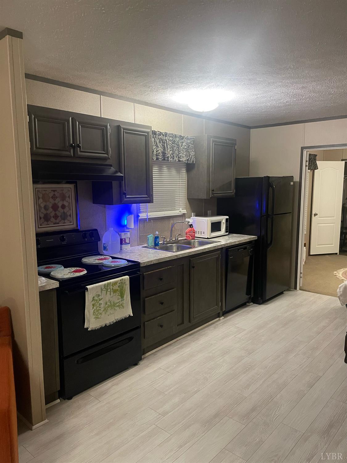 801 Purdum Mill Road Appomattox, VA 24522 - Photo 20 of 68 a kitchen with stainless steel appliances granite countertop a stove and a refrigerator