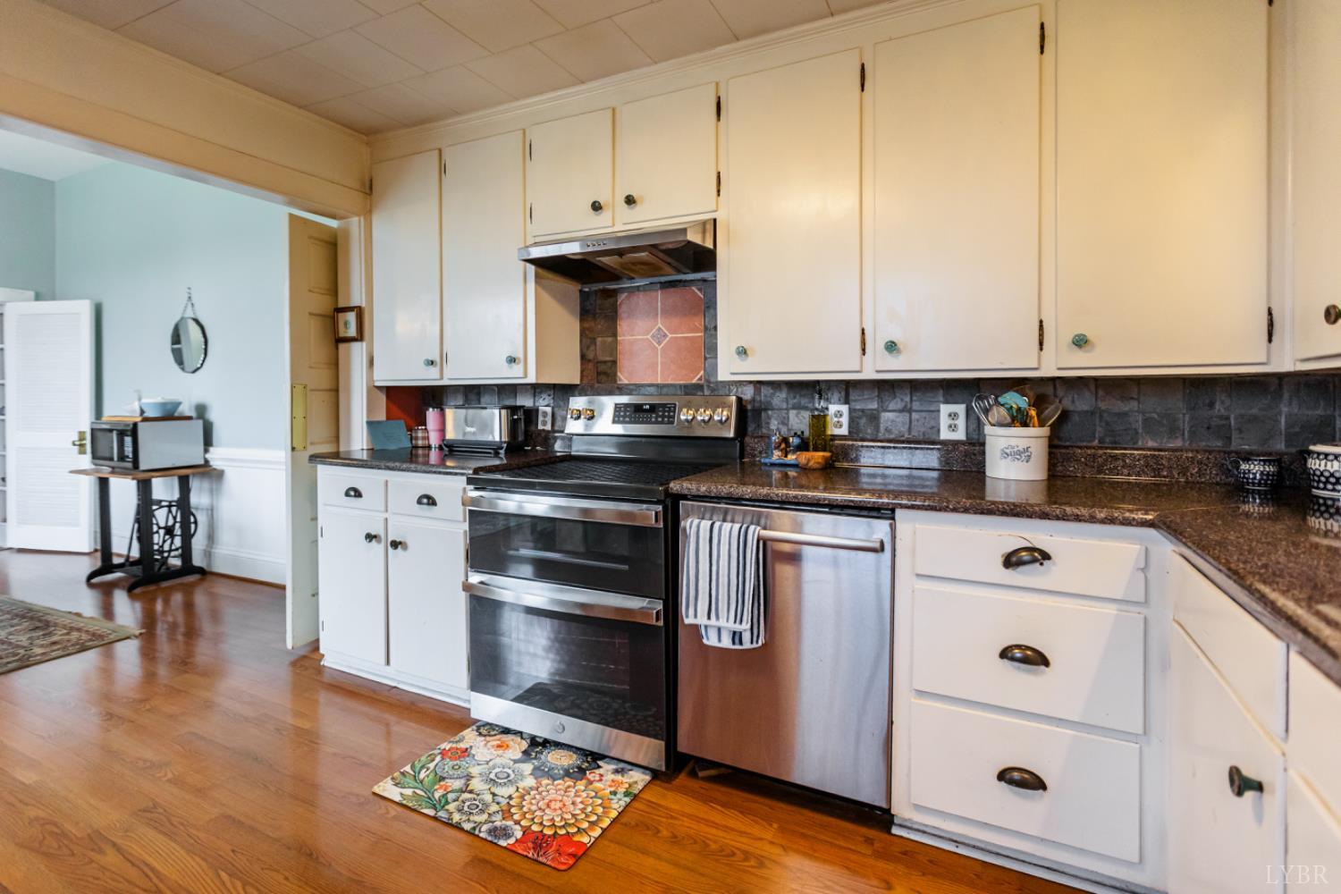 801 Purdum Mill Road Appomattox, VA 24522 - Photo 30 of 68 a kitchen with stainless steel appliances granite countertop a sink a stove and cabinets