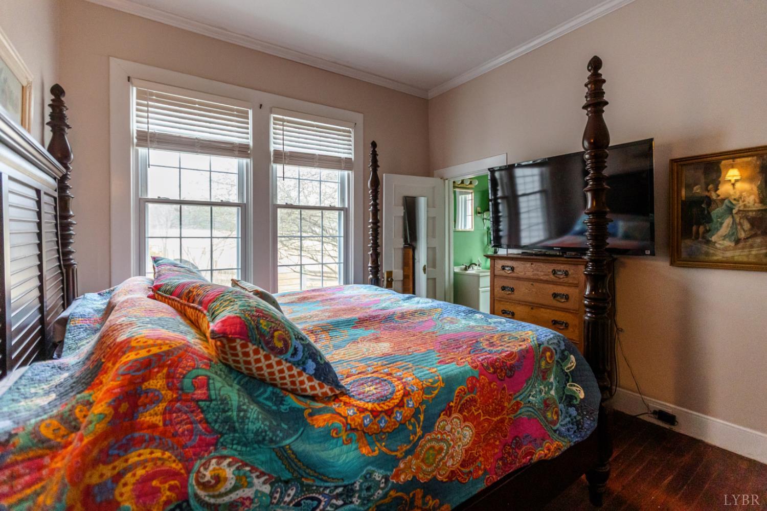 801 Purdum Mill Road Appomattox, VA 24522 - Photo 35 of 68 a bedroom with a bed a flat screen tv and a window