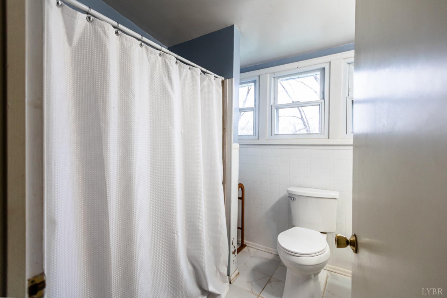 801 Purdum Mill Road Appomattox, VA 24522 - Photo 44 of 68 a white toilet sitting next to a shower curtain