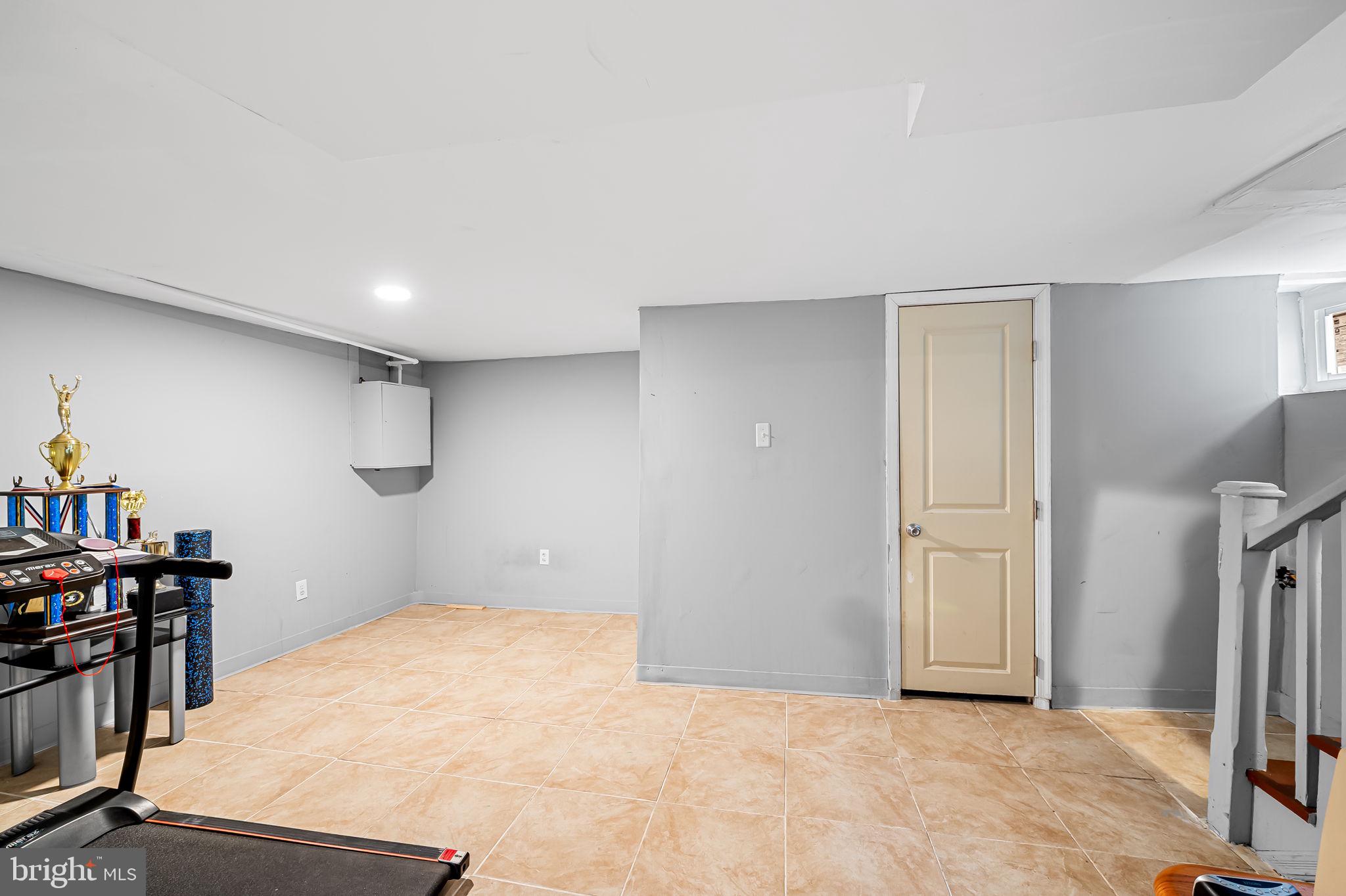 2908 East Cold Spring Lane Baltimore, MD 21214 - Photo 13 of 19 a view of a room with refrigerator and wooden floor