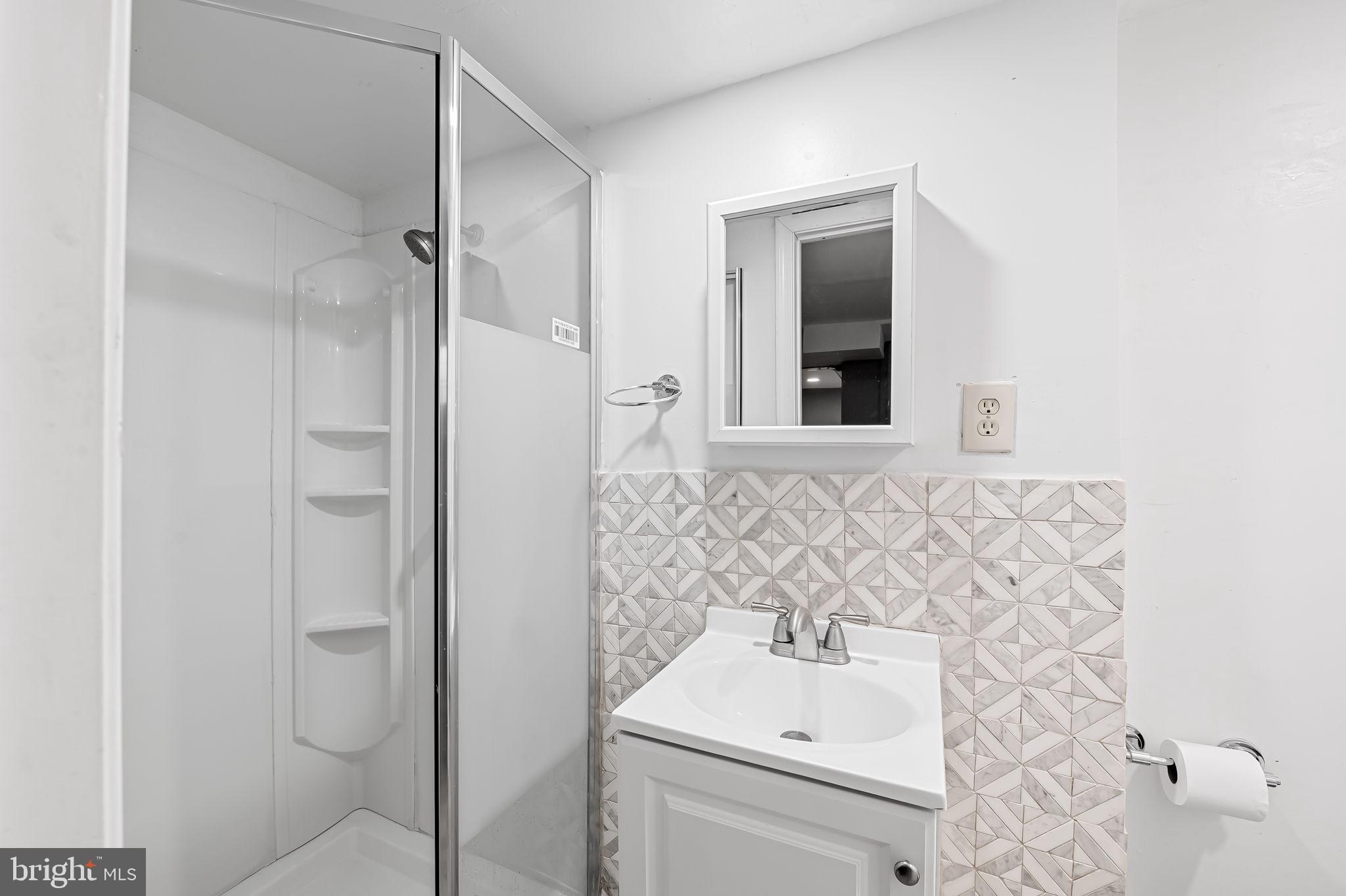 2908 East Cold Spring Lane Baltimore, MD 21214 - Photo 15 of 19 a bathroom with a sink toilet and shower