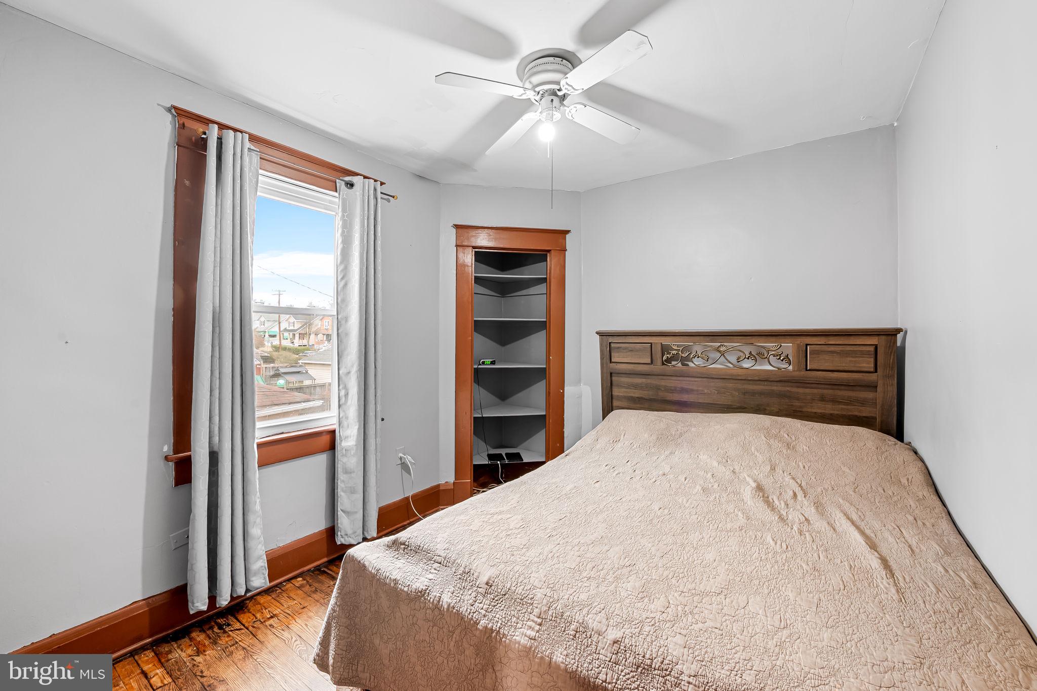 2908 East Cold Spring Lane Baltimore, MD 21214 - Photo 8 of 19 a bedroom with a bed and a window