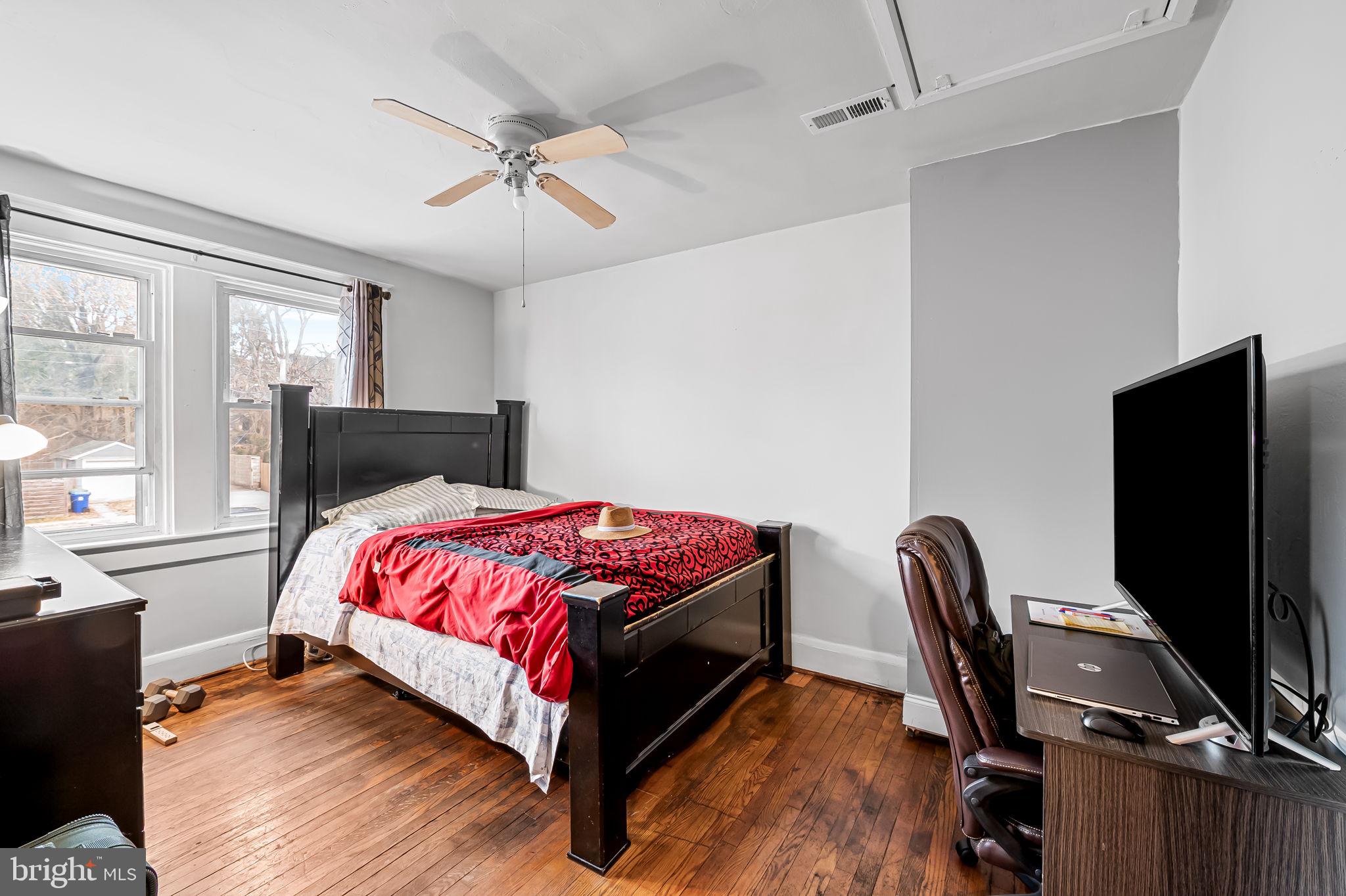 2908 East Cold Spring Lane Baltimore, MD 21214 - Photo 9 of 19 a bed room with a bed window and a chair