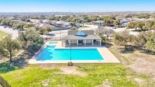 an aerial view of residential houses with yard