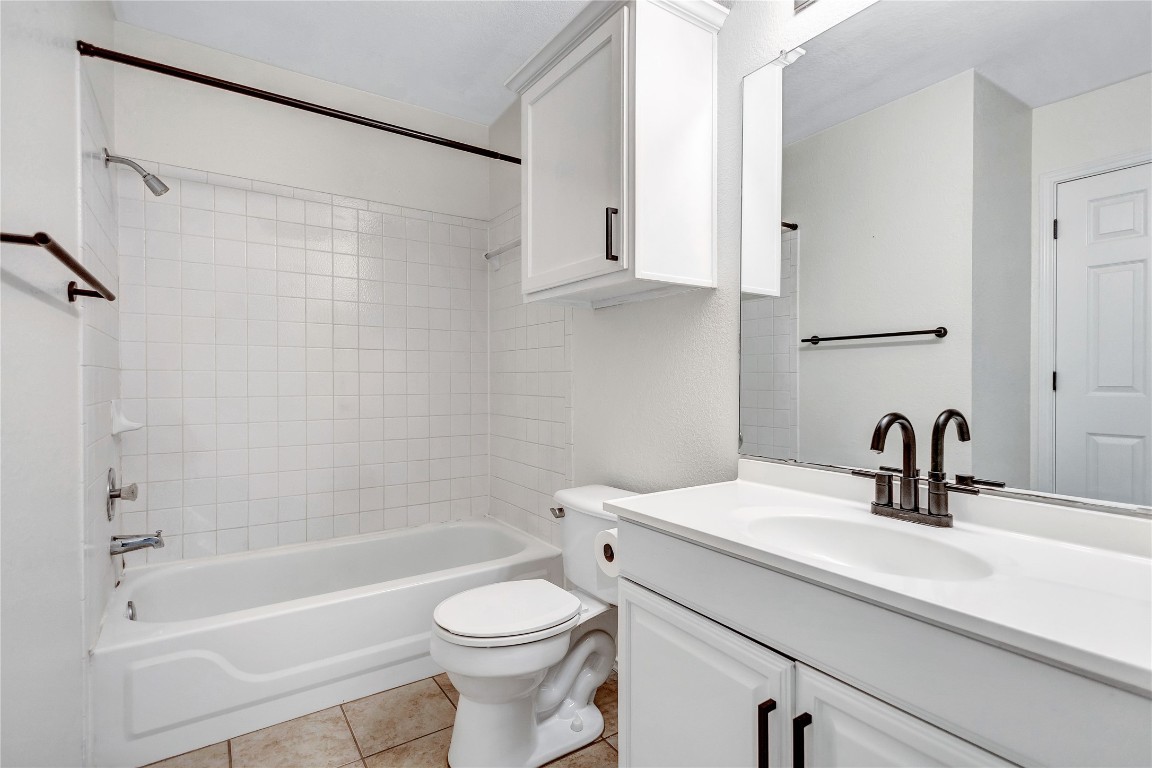 17616 Strontian Pass Pflugerville, TX 78660 - Photo 12 of 20 a bathroom with a sink a toilet and a bathtub