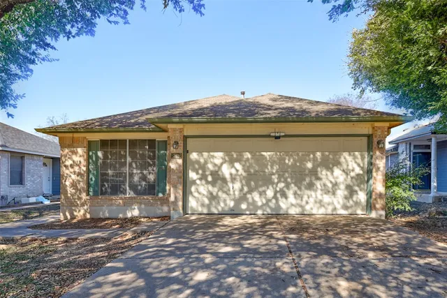 a backyard of a house with large trees and outdoor seating