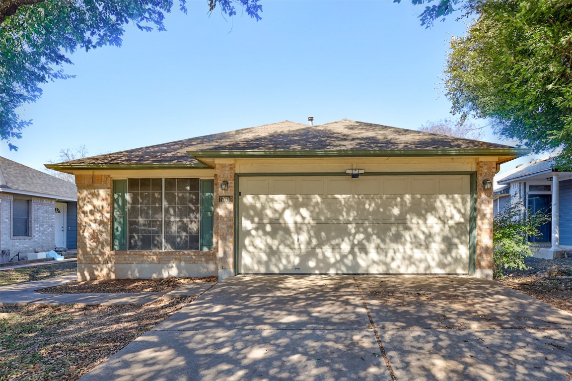 17616 Strontian Pass Pflugerville, TX 78660 - Photo 17 of 20 a backyard of a house with large trees and outdoor seating