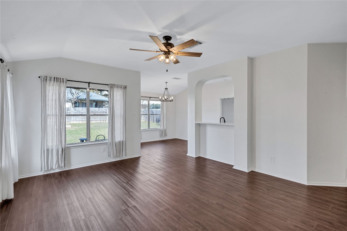 17616 Strontian Pass Pflugerville, TX 78660 - Photo 3 of 20 a view of an empty room with window and wooden floor