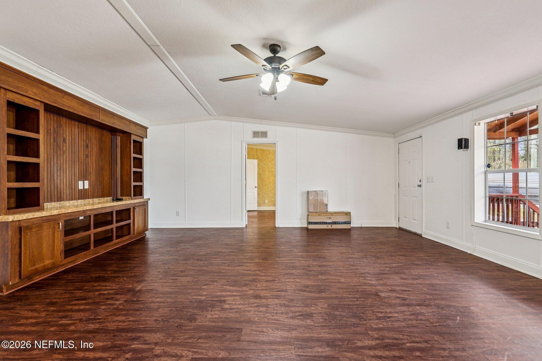 13725 Webb Road Jacksonville, FL 32218 - Photo 9 of 61 a view of an empty room with window and wooden floor