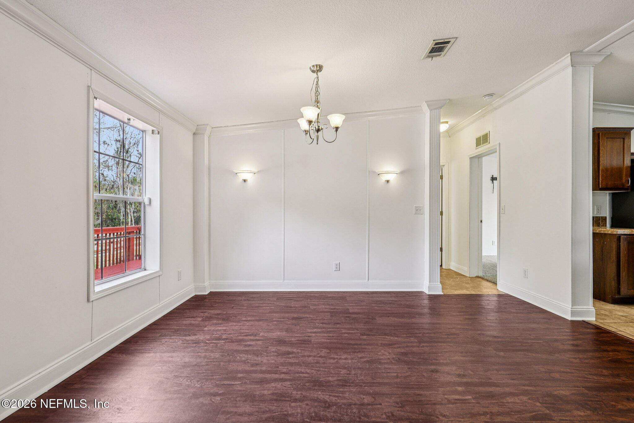 13725 Webb Road Jacksonville, FL 32218 - Photo 13 of 61 an empty room with wooden floor and windows