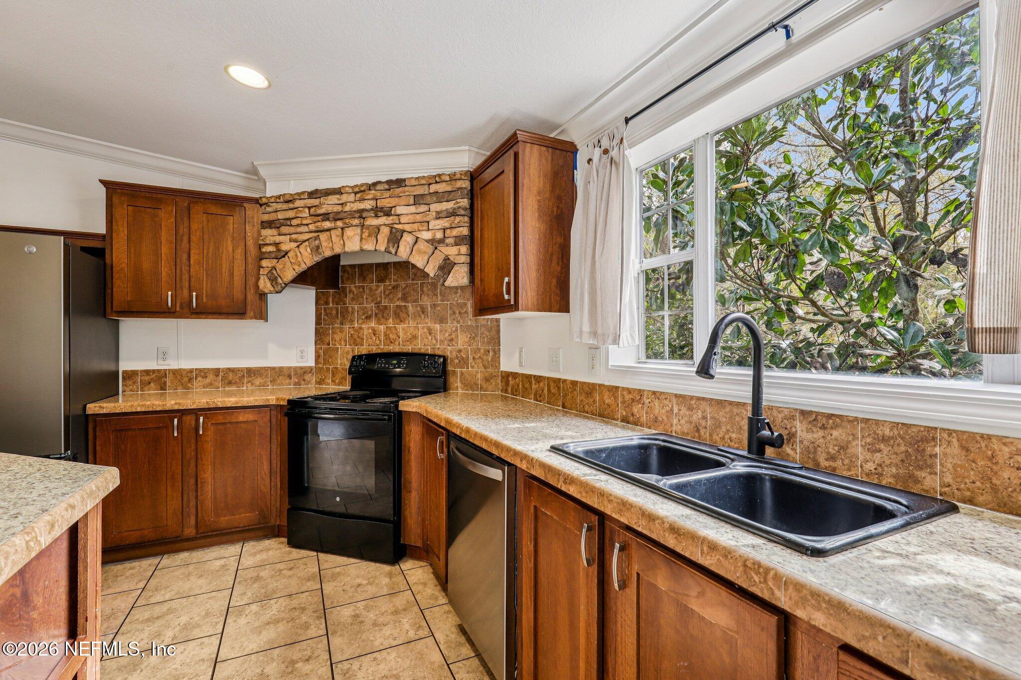 13725 Webb Road Jacksonville, FL 32218 - Photo 17 of 61 a kitchen with a sink and a refrigerator
