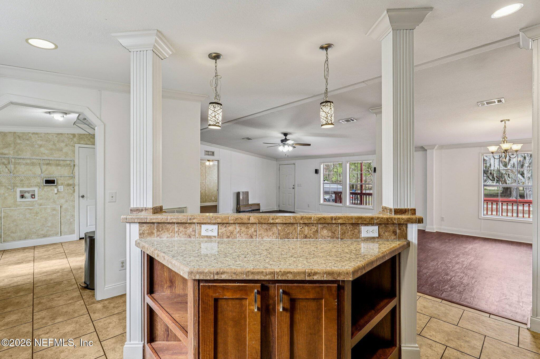 13725 Webb Road Jacksonville, FL 32218 - Photo 18 of 61 a kitchen with granite countertop cabinets and a chandelier