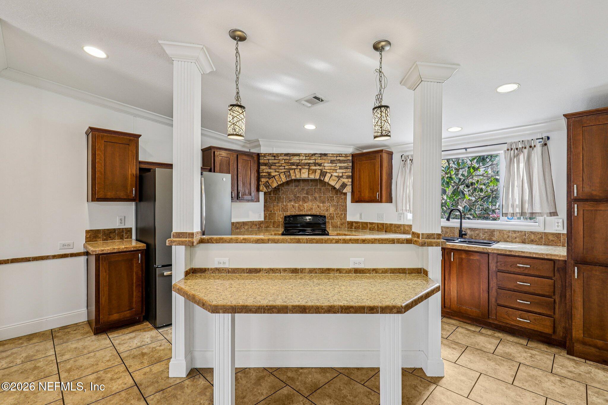 13725 Webb Road Jacksonville, FL 32218 - Photo 20 of 61 a view of living room kitchen with stainless steel appliances granite countertop cabinets and fireplace