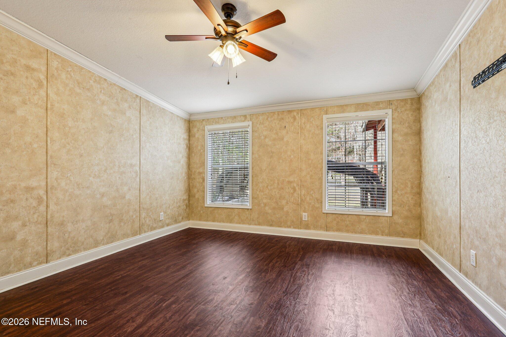 13725 Webb Road Jacksonville, FL 32218 - Photo 23 of 61 an empty room with wooden floor fan and windows
