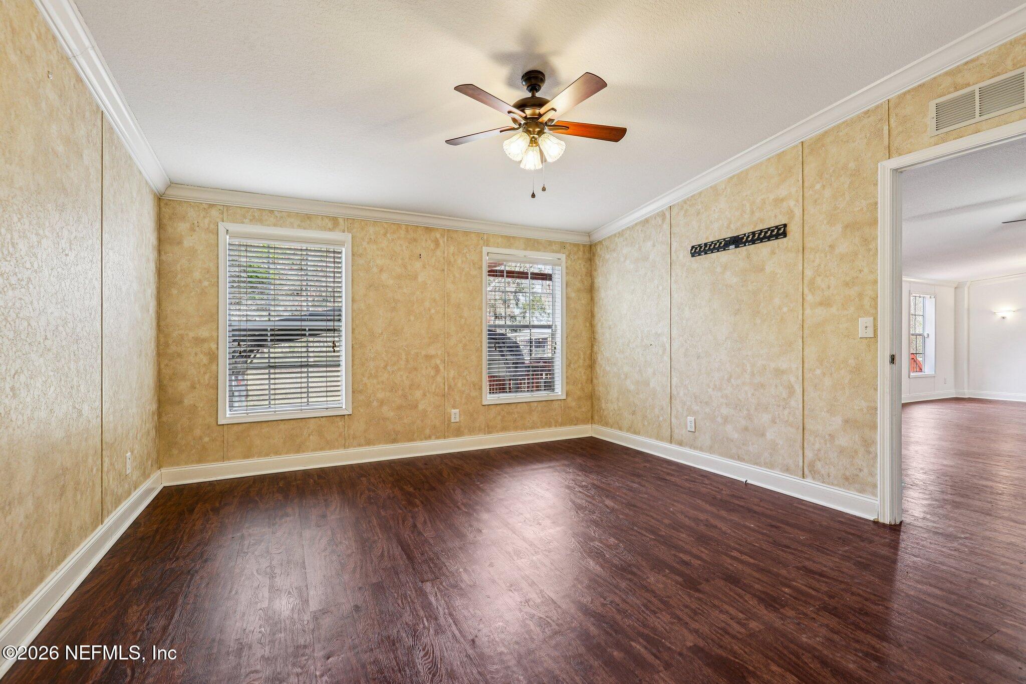 13725 Webb Road Jacksonville, FL 32218 - Photo 24 of 61 a view of an empty room with wooden floor and a window