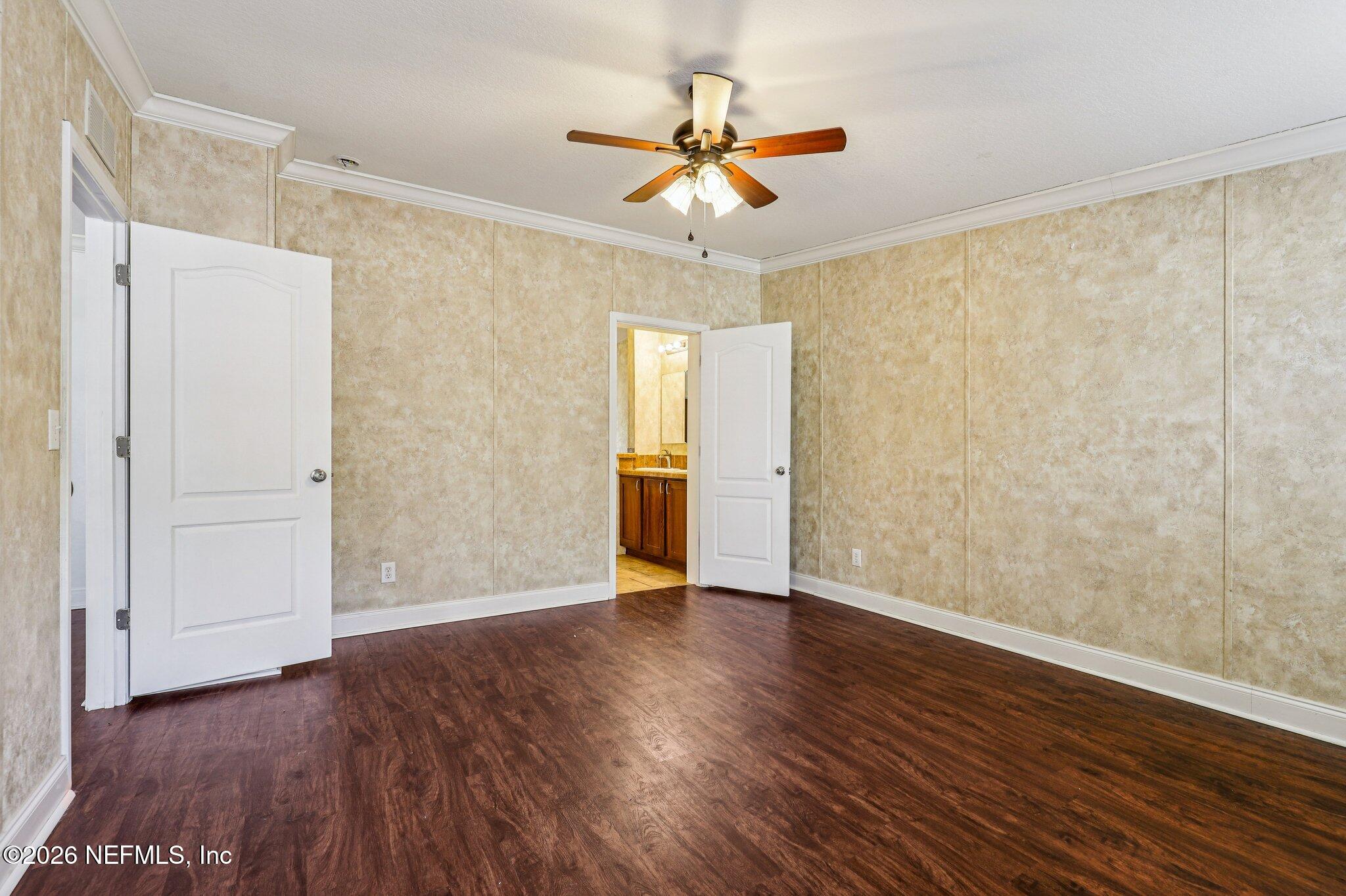 13725 Webb Road Jacksonville, FL 32218 - Photo 25 of 61 a view of an empty room with window and wooden floor