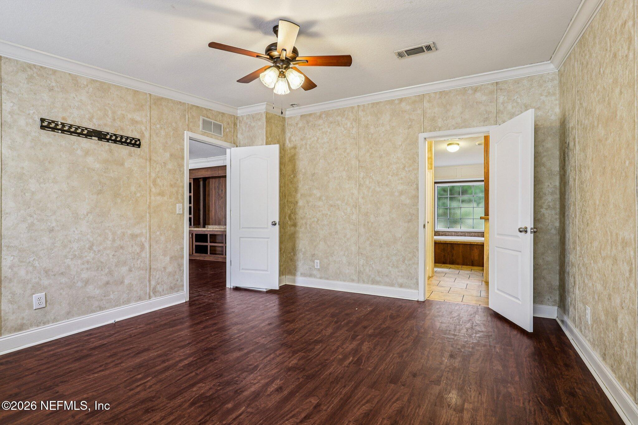 13725 Webb Road Jacksonville, FL 32218 - Photo 26 of 61 an empty room with wooden floor and a ceiling fan