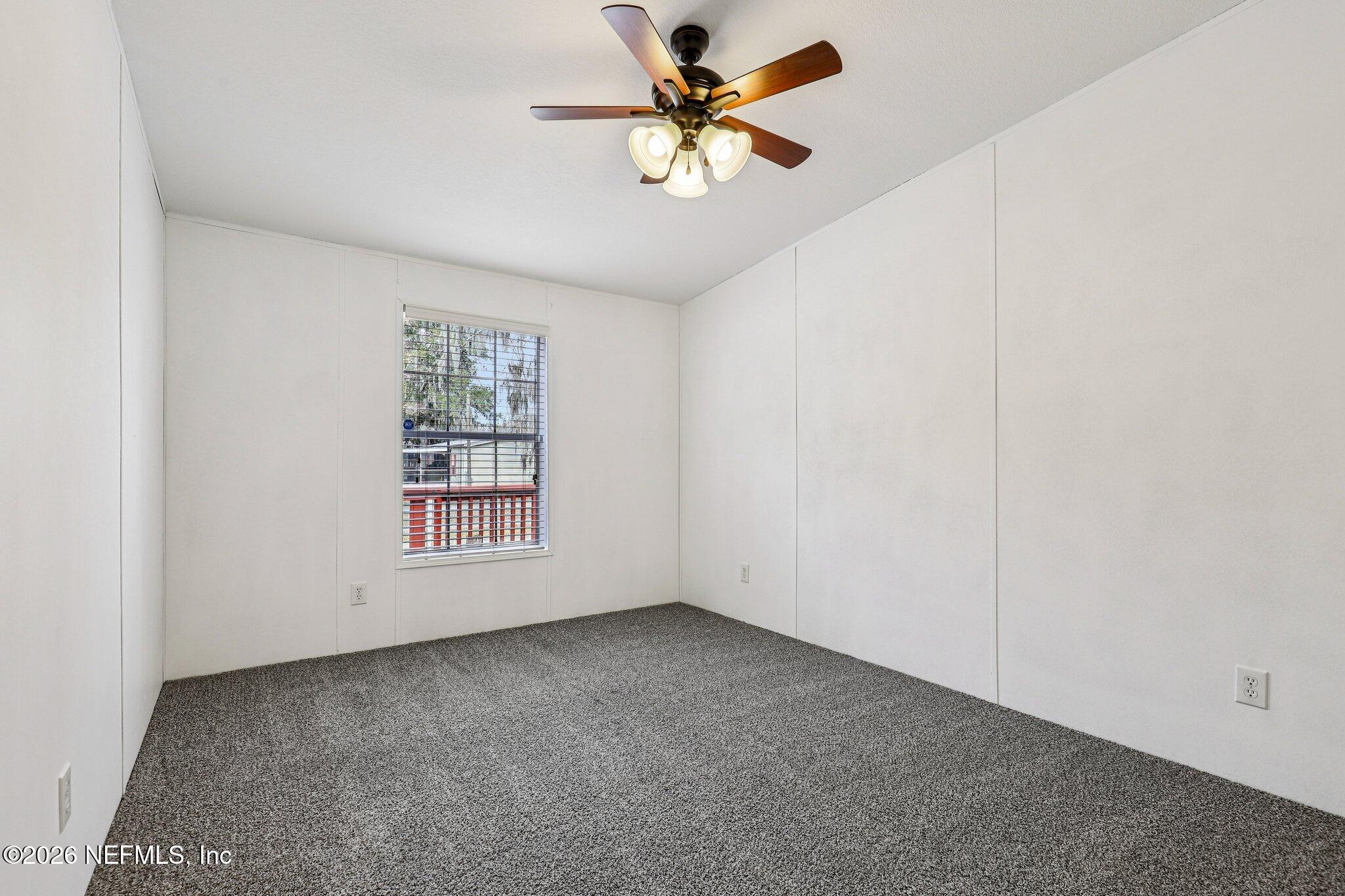 13725 Webb Road Jacksonville, FL 32218 - Photo 36 of 61 an empty room with windows and fan