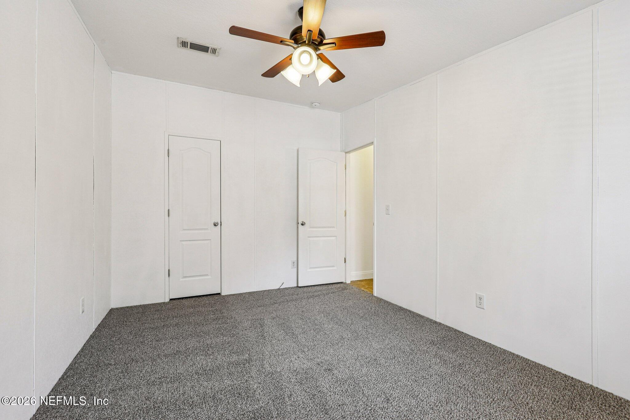 13725 Webb Road Jacksonville, FL 32218 - Photo 37 of 61 an empty room with a ceiling fan and a fan