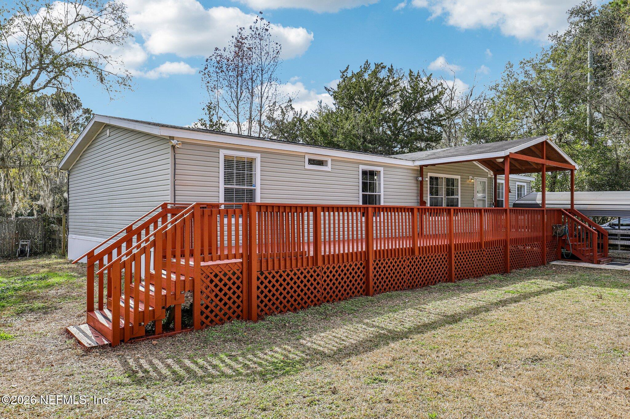 13725 Webb Road Jacksonville, FL 32218 - Photo 4 of 61 a view of a house with a yard and wooden fence