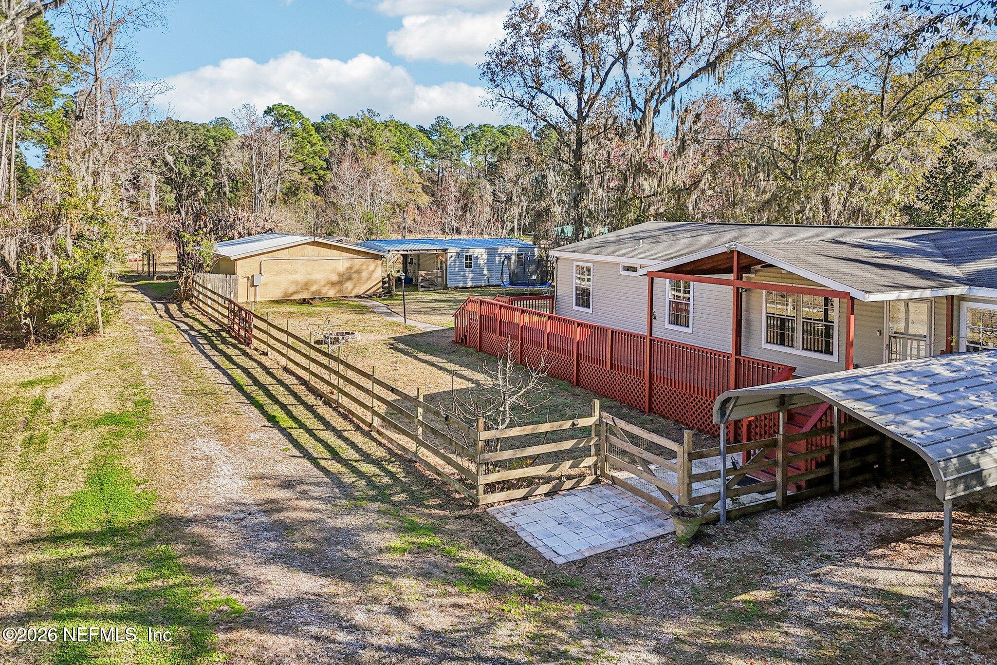 13725 Webb Road Jacksonville, FL 32218 - Photo 46 of 61 a view of a house with a yard