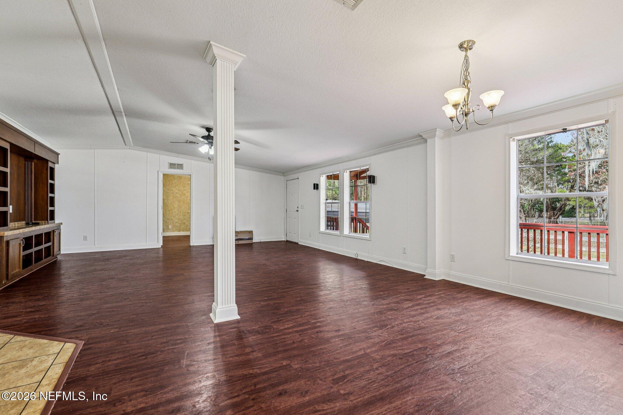 13725 Webb Road Jacksonville, FL 32218 - Photo 61 of 61 a view of an empty room with wooden floor ceiling fan and windows