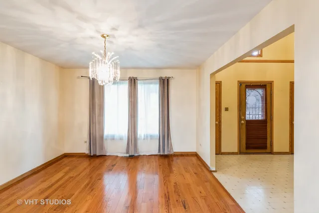 a view of an empty room with a fireplace and a window