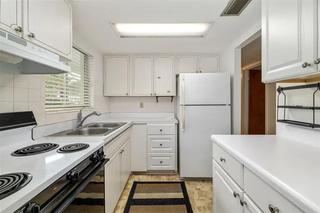 a kitchen with a stove a refrigerator and a stove
