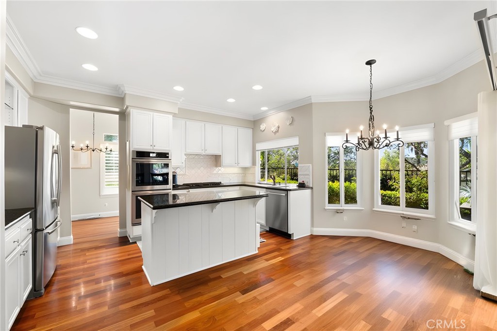 28561 Camelback Road Trabuco Canyon, CA 92679 - Photo 13 of 66 a kitchen with stainless steel appliances granite countertop a refrigerator a sink dishwasher a stove and a wooden floor