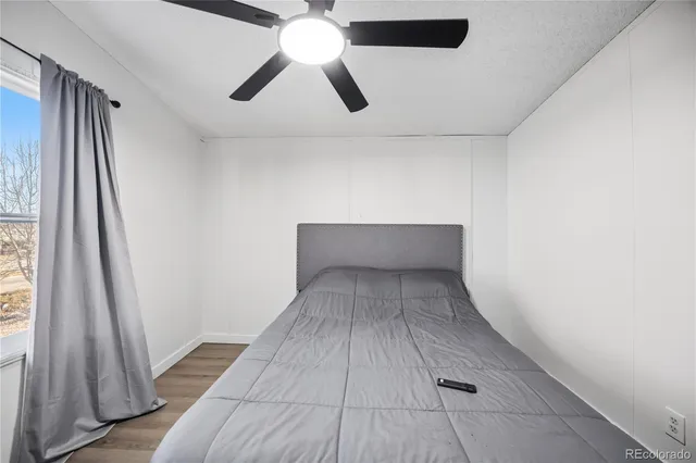 en empty room with wooden floor and windows