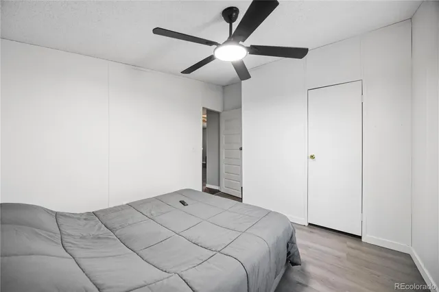 a bedroom with a bed and a ceiling fan