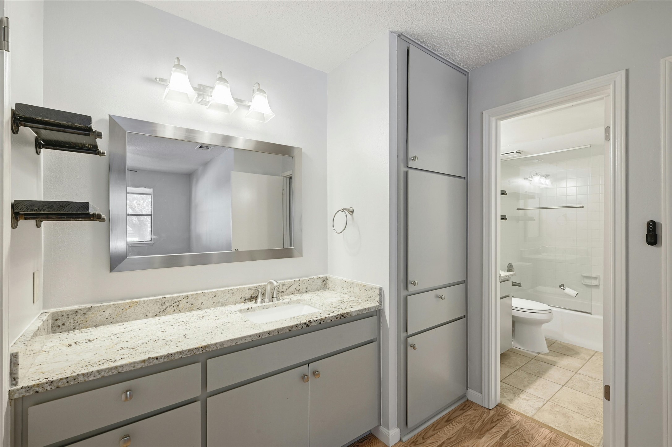 9226 Jollyville Road, Unit 221 Austin, TX 78759 - Photo 15 of 20 Granite counters and light-hued cabinetry create a pristine and inviting bathroom space.
