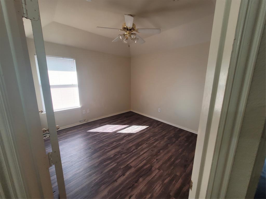 244 Wyndham Meadows Way Wylie, TX 75098 - Photo 7 of 12 a view of a room with wooden floor and a ceiling fan