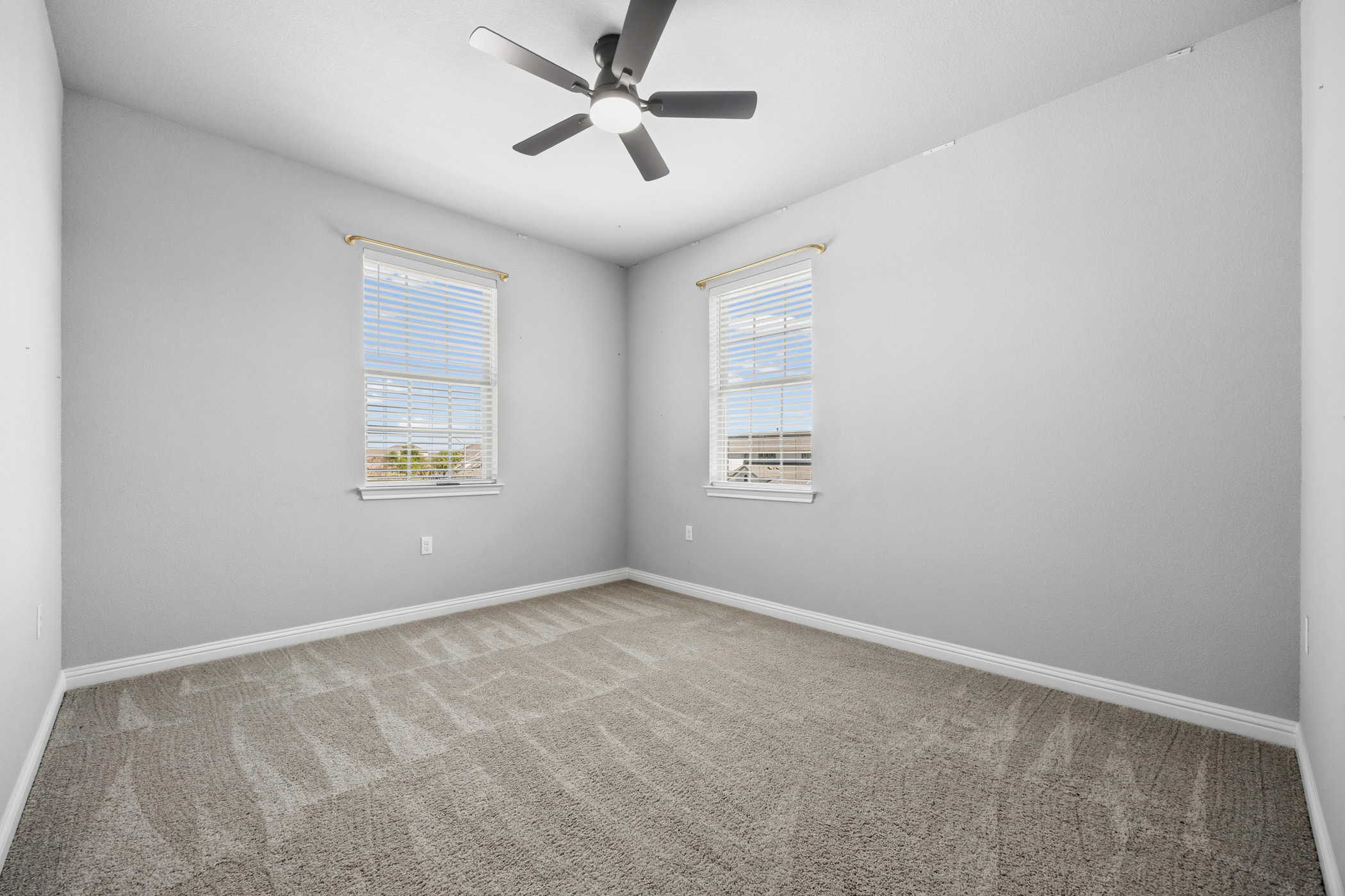 2209 Littleleaf Lane Leander, TX 78641 - Photo 20 of 27 Spare room with light colored carpet and a ceiling fan