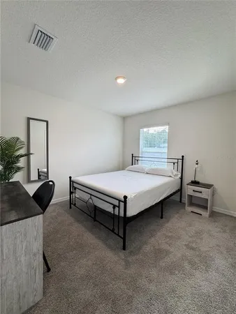a bedroom with a bed and a table in it