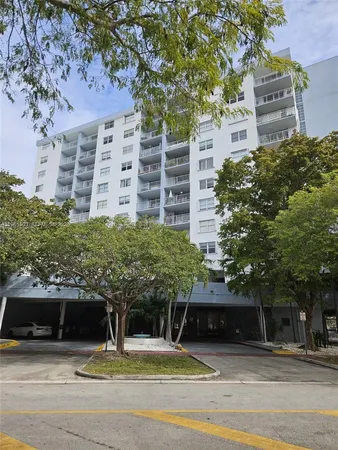 a view of a building with car parked