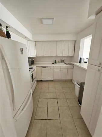 a kitchen with a cabinets and a stove top oven