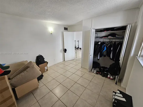 a bedroom with a bed and a mirror