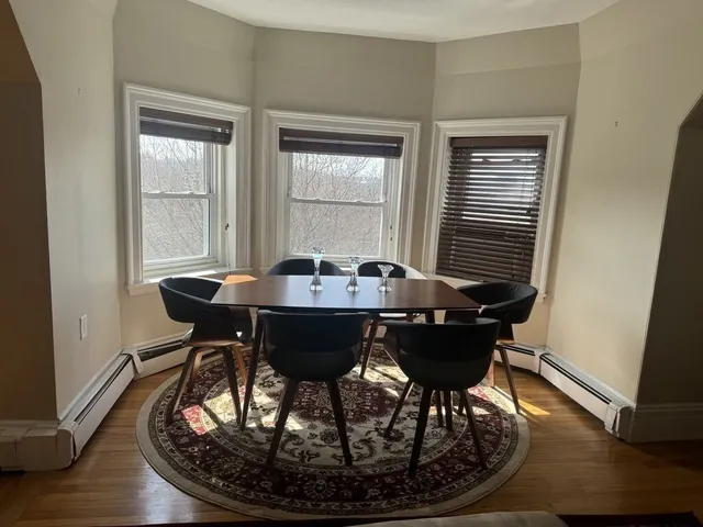a view of a dining room with furniture window and wooden floor