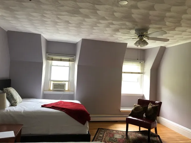 a bedroom with a bed and window