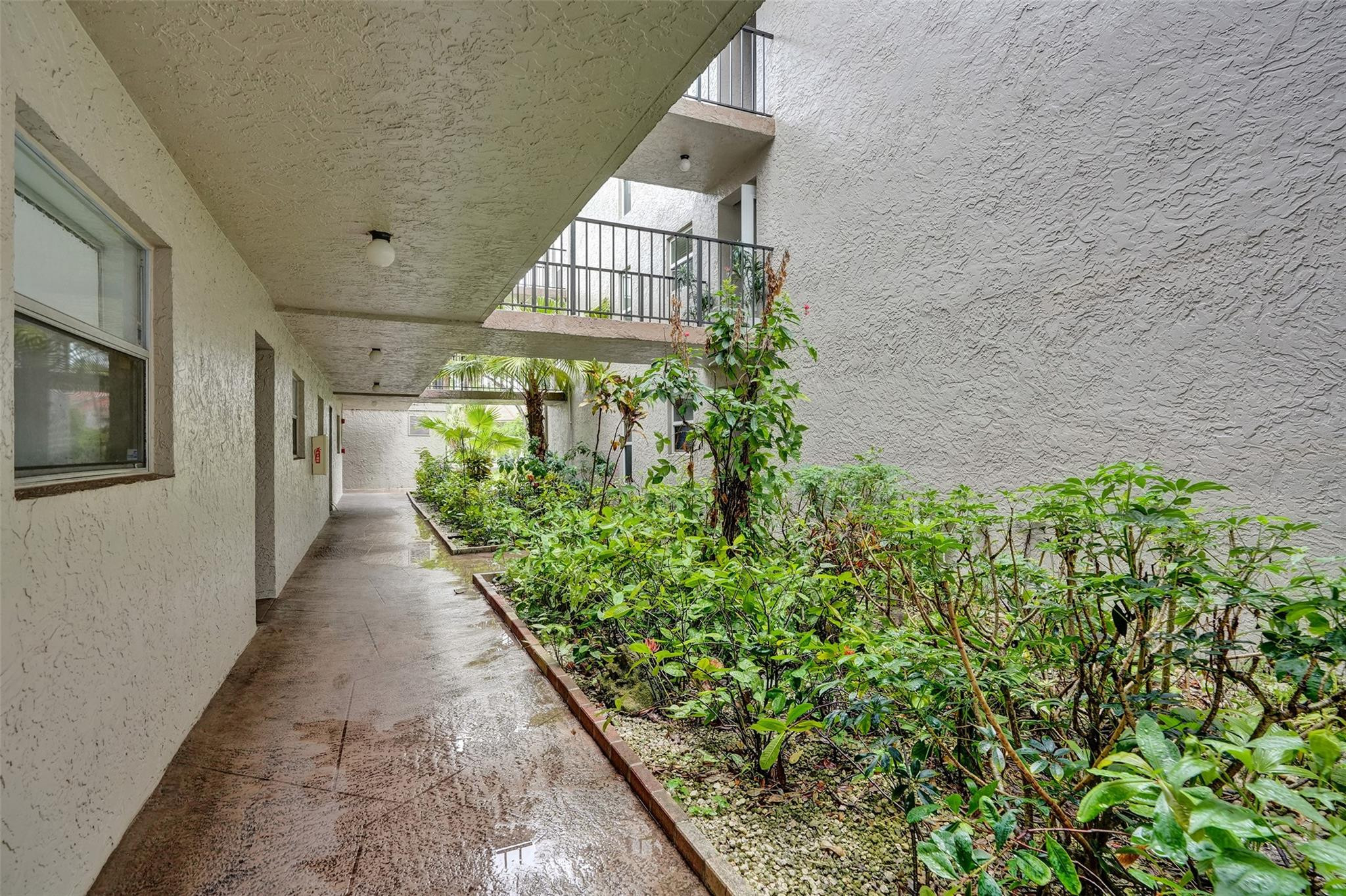 3100 Riverside Drive, Unit 109 Coral Springs, FL 33065 - Photo 21 of 28 a view of a pathway in outside of the house