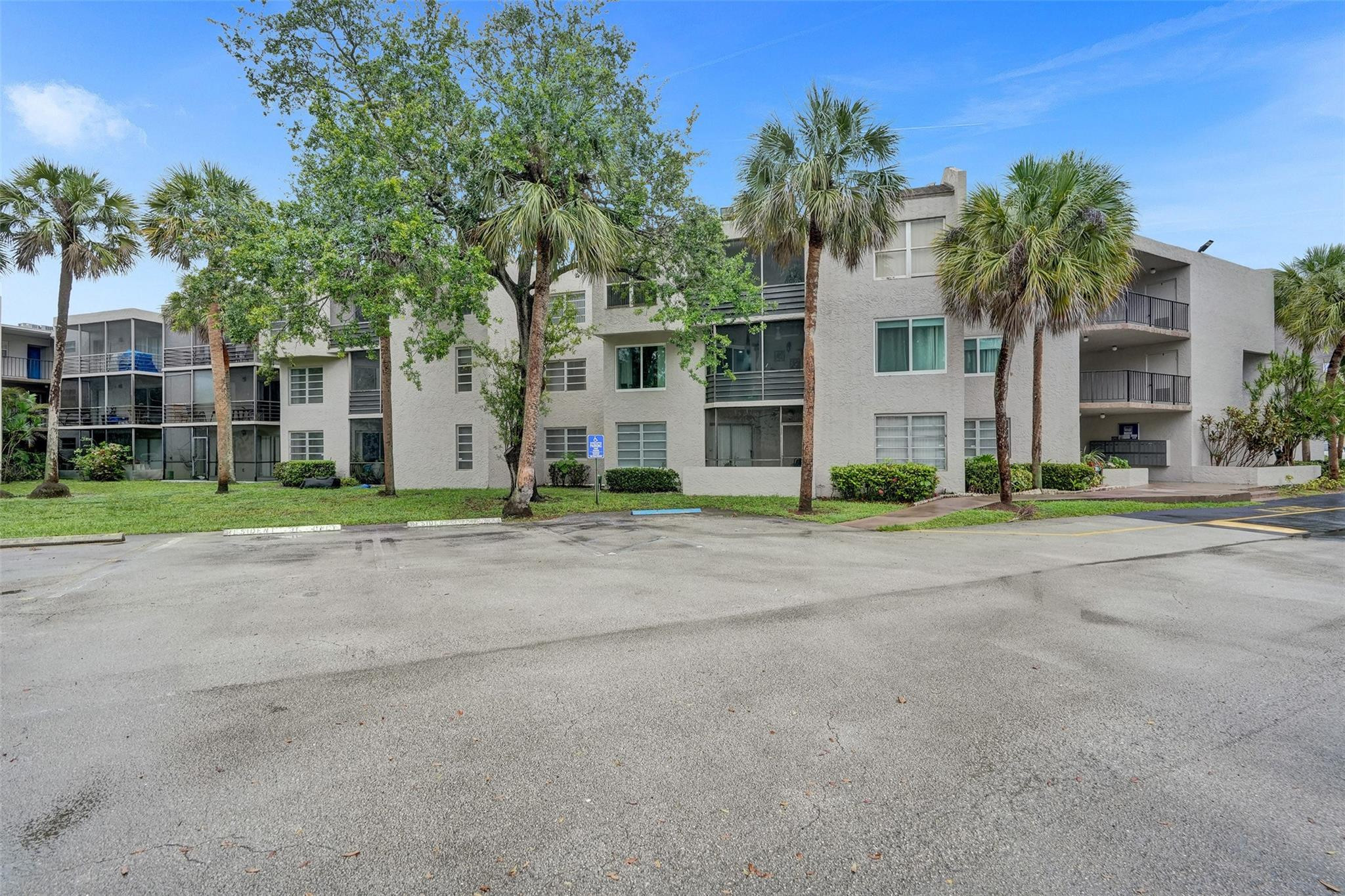 3100 Riverside Drive, Unit 109 Coral Springs, FL 33065 - Photo 25 of 28 a front view of house with yard and green space