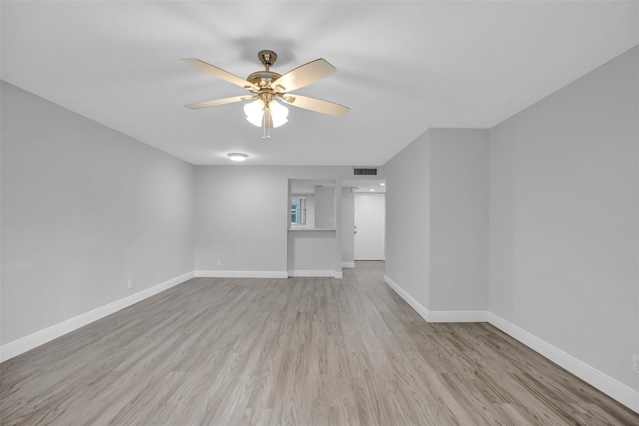 3100 Riverside Drive, Unit 109 Coral Springs, FL 33065 - Photo 8 of 28 a view of an empty room and wooden floor