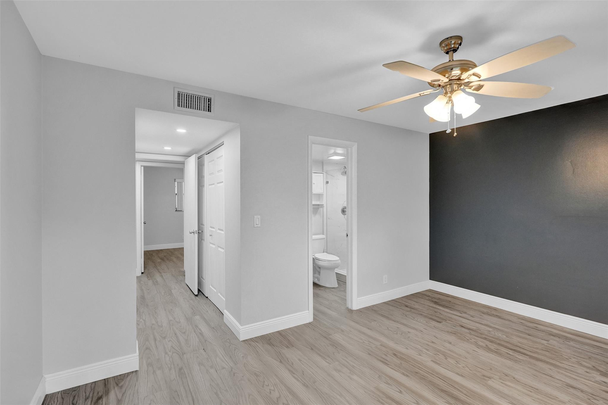 3100 Riverside Drive, Unit 109 Coral Springs, FL 33065 - Photo 9 of 28 wooden floor in an empty room with a window